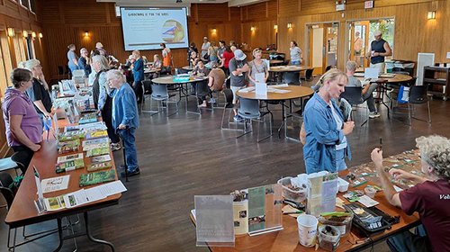 People gathered in a room talking with one another