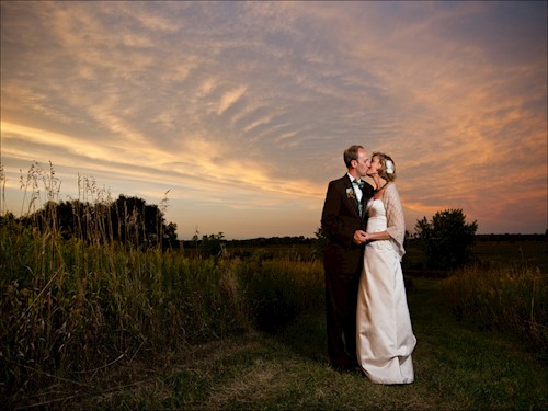 Couple in the prairie at sunset